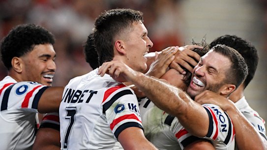 The Roosters celebrate a try.