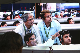 Indian Space Research Organisation scientists watch a screen at their Telemetry, Tracking and Command Network facility in Bangalore on Saturday as the spacecraft approached the moon.