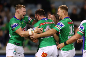 Matt Frawley is mobbed by his Canberra teammates after scoring a try.