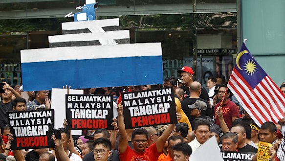 Protesters with an effigy of the luxury yacht Equanimity, which belongs to businessman Jho Low, one of the figures at the centre of the 1MDB sovereign wealth scandal.