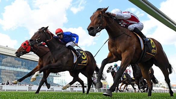 Hugh Bowman rides Flit to a three-way photo finish win at the Thousand Guineas.