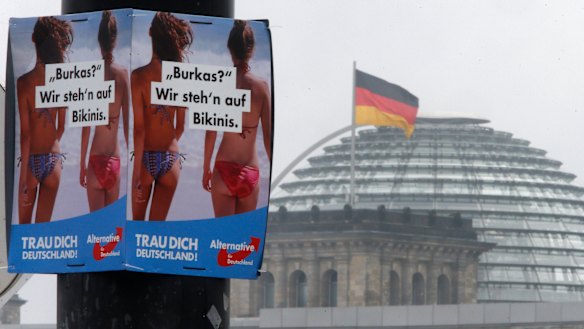 A poster of the far-right Alternative for Germany reads "Burqa? We prefer bikinis" near the Reichstag building in Berlin.