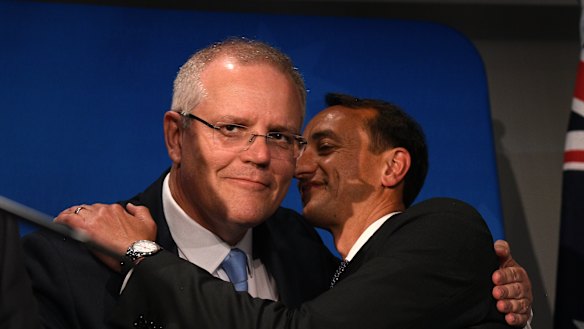 Prime Minister Scott Morrison embraces Liberal candidate Dave Sharma prior to his concession speech.