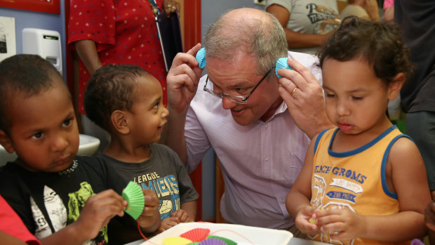 Mr Morrison, as social services minister jokes with children during a visit to a childcare centre in 2015.