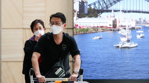 Passengers from Wuhan arrive at Sydney Airport wearing masks. 