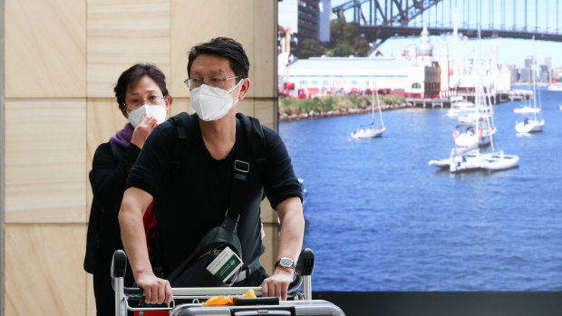 Passengers from Wuhan arrive at Sydney Airport wearing masks. 