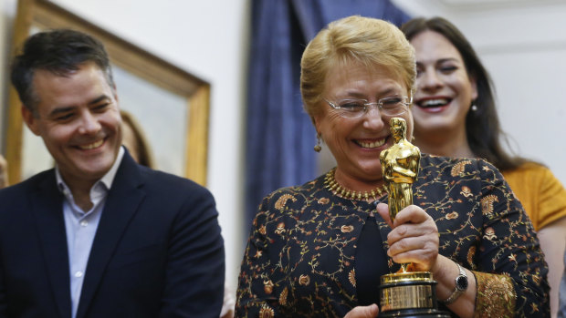 Then Chile's president Michelle Bachelet holds the Oscar statuette during a meeting with Sebastian Lelio, left, and Daniela Vega, right, director and actress of the Oscar winning foreign language film "A Fantastic Woman" days before the end of her term in March.
