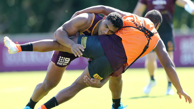 Pangai tackles during a Broncos training session.