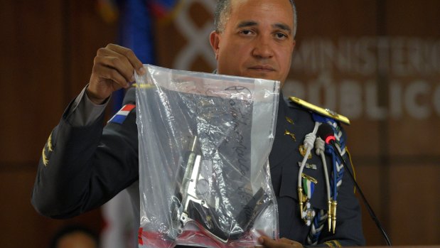 Director of the National Police, General Ney Aldrin Bautista Almonte, with the weapon used to shoot Ortiz.