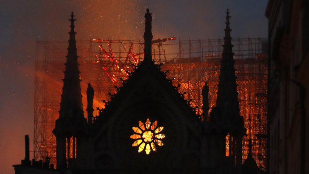 Flames and smoke rise from Notre Dame cathedral as it burns in Paris.