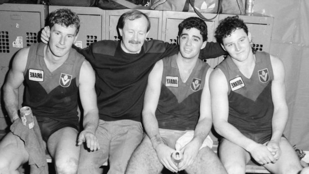 Melbourne coach John Northey with his players in the locker room.