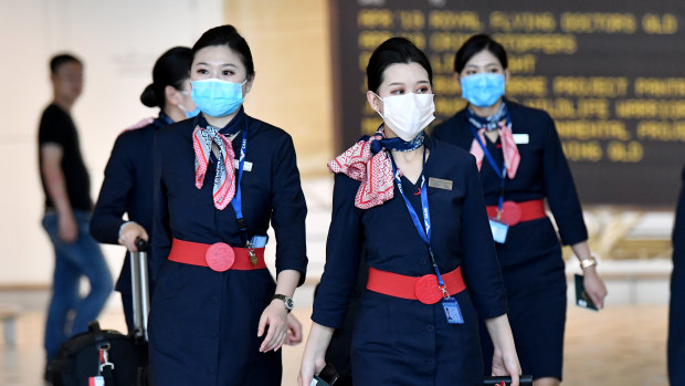 China Eastern Airlines cabin crew are seen wearing protective face masks at Brisbane International Airport on Wednesday.