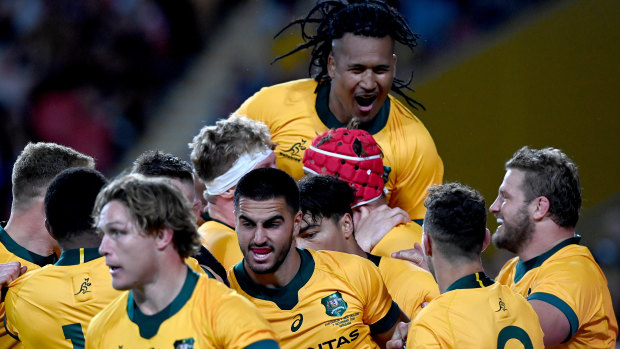 The Wallabies celebrate a try against the All Blacks last year. 