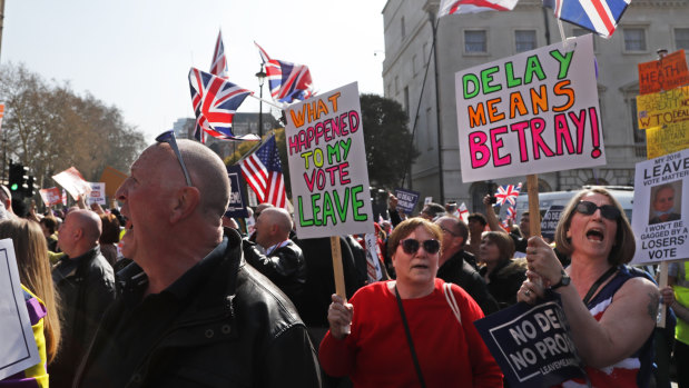 Crowds protested in Parliament Square as May's deal was defeated.