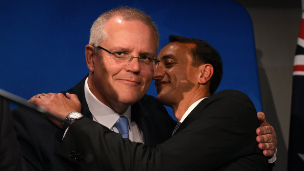 Prime Minister Scott Morrison embraces Liberal candidate Dave Sharma prior to his concession speech.
