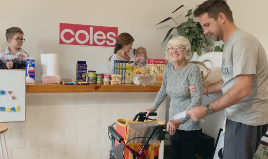 “People were talking about what was going on in our little house in Forresters Beach on a global scale”: Jason Genderen takes his mother shopping at a supermarket he set up in his home.