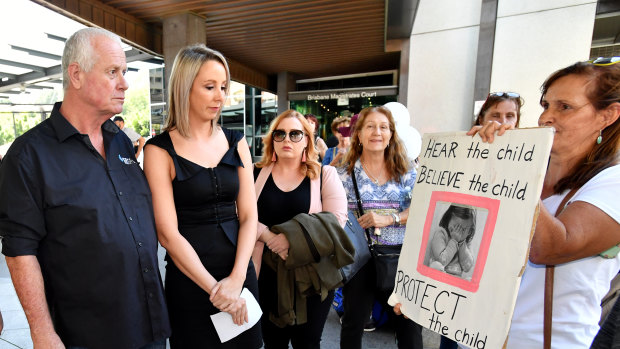 Patrick O'Dea (left), seen with supporters as he leaves the Brisbane Magistrates Court in Brisbane on Friday, is among those charged along with William Russell Massingham Pridgeon.