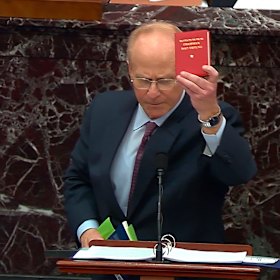David Schoen, an attorney for former President Donald Trump brandishes Mao Zedong’s Little Red Book as he speaks. 