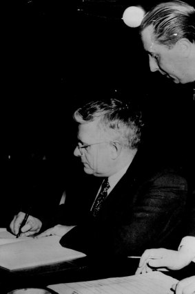 Dr. Herbert V. Evatt, President of the United Nations General Assembly, signs - on behalf of his country - the UN convention outlawing genocide.