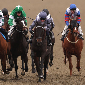 Billy Loughnane, centre in grey silks, wins on Wide Margin at Lingfield Park in England on November 19.