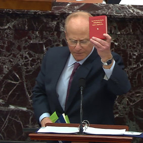 David Schoen, an attorney for former President Donald Trump brandishes Mao Zedong’s Little Red Book as he speaks. 