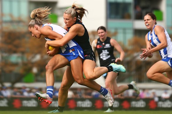 Abbie McKay of the Blues tackles Alice O’Loughlin of the Kangaroos in round five.