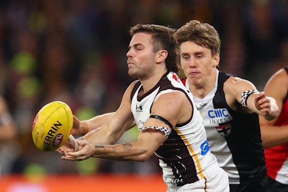 Nick Watson handballs against the Saints.