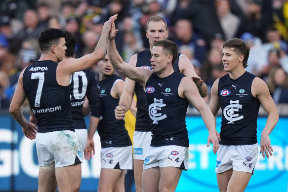 Carlton players get around Matt Owies after his goal against Richmond.