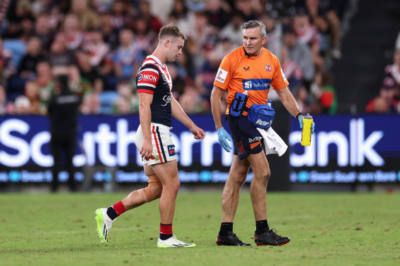 Sam Walker leaves the field after a head knock in the match against Souths.