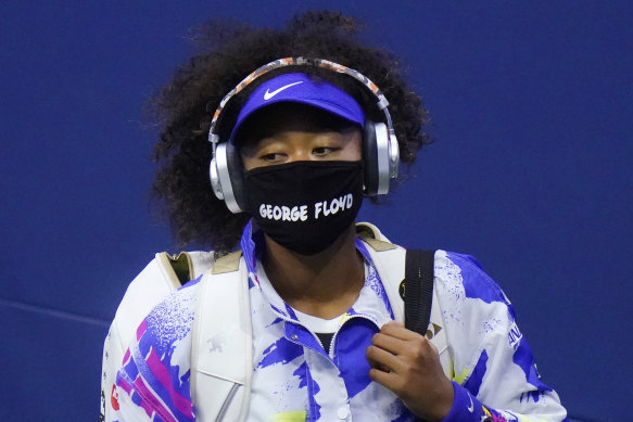 Naomi Osaka wears a COVID-19 mask featuring the name George Floyd, while arriving on court during the 2020 Us Open.
