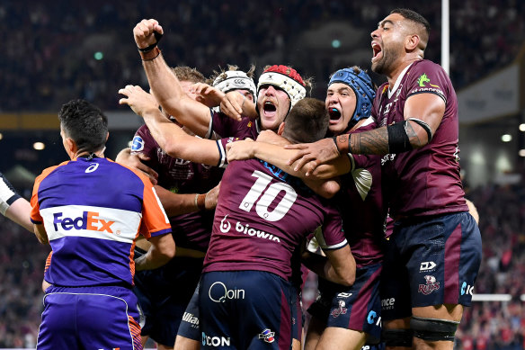 James O’Connor of the Reds is congratulated by team mates after scoring the match winning try.