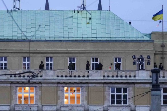 Police officers stand on the balcony of Philosophical Faculty of Charles University in downtown Prague.