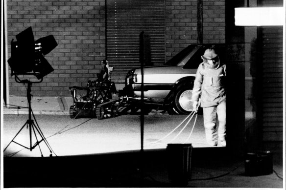 Army experts looking over the car. 