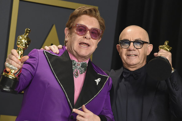 Elton John and Bernie Taupin celebrate their Oscars for (I’m Gonna) Love Me Again from Rocketman in 2020