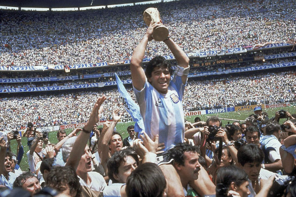 Argentina’s captain Maradona holds up the World Cup after his side beat West Germany in the 1986 final.