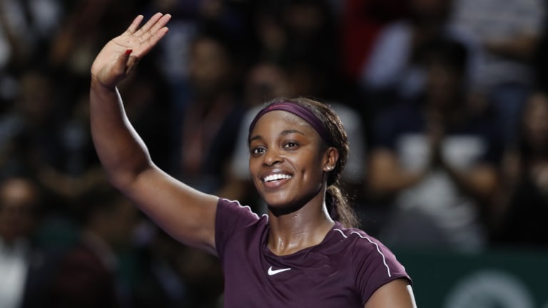 All smiles: Sloane Stephens waves to the crowd after beating Naomi Osaka in Singapore.
