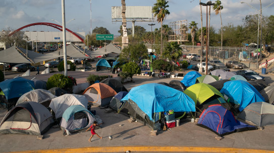 A camp for asylum seekers stands next to the international bridge to the United States in Matamoros, Mexico. More than 1,000 Central American and Mexican asylum seekers have been staying, many for months between immigration court hearings, in a squalid camp here.