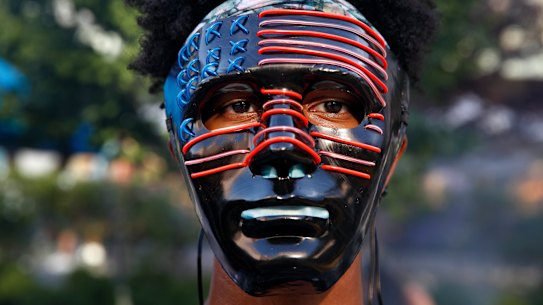 Darius Scott, 17, of Germantown, Maryland, wears a mask he designed and made himself to a protest a street that's been renamed Black Lives Matter Plaza.