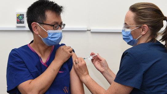 Professor Allen Cheng, left, co-chair of ATAGI, received the Pfizer vaccine at The Alfred hospital in March.