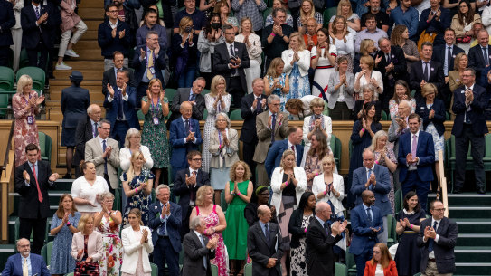 Spectators in the Royal Box stand for Oxford Professor Sarah Gilbert (seated in red, bottom right), one of the people behind the Astra Zeneca COVID-19 vaccine ahead of the opening match on day 1 of The Championships - Wimbledon 2021.