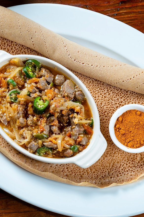 Stew-style stir fry served with injera.