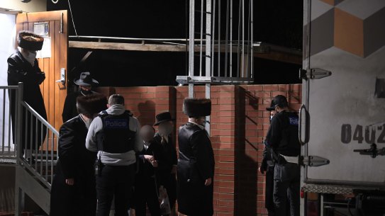 Police take details from people outside the synagogue on Tuesday night.