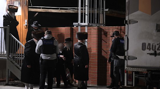 Police take details from people outside a synagogue in Ripponlea last week.