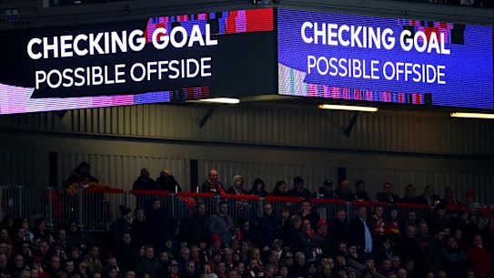 A VAR check takes place during a Premier League game.