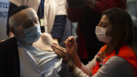 Joseph Zalman Kleinman, 92, a Holocaust survivor, receives his second dose of the Pfizer vaccine for COVID-19 at a sports arena in Jerusalem last month. 