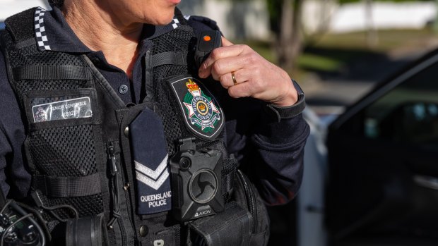Qld police officer struck over head with glass bottle, two charged