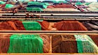 Imported iron ore sits at the Qingdao Port Ore Terminal in China’s Shandong Province.