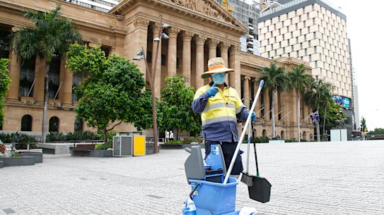 A cleaner in an empty King George Square in Brisbane's CBD on Saturday.