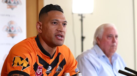 Israel Folau, pictured with backer Clive Palmer, said on Friday he was excited to return to the “grassroots level”.
