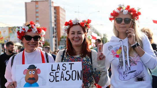 Women with a wreath on their heads pose for a photo during a Belarusian opposition supporters' rally protesting the official presidential election results in Minsk, Belarus.